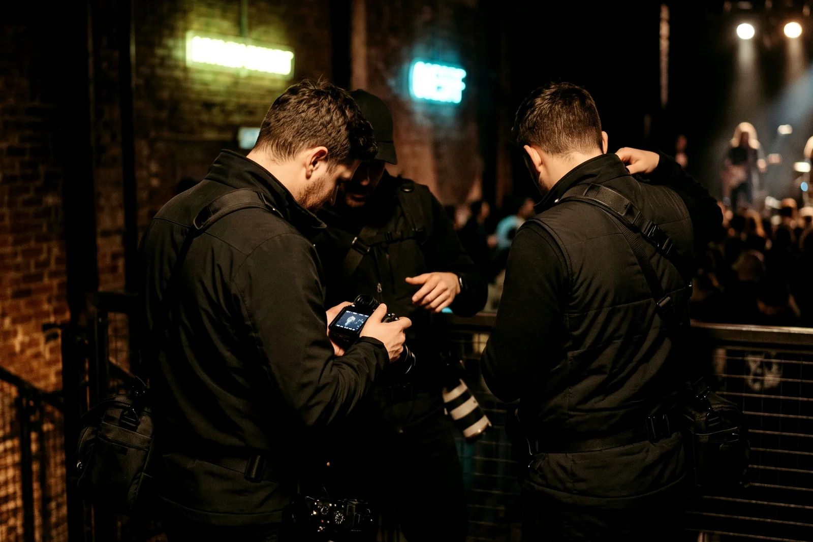 A uniformed pro photographer working a night venue